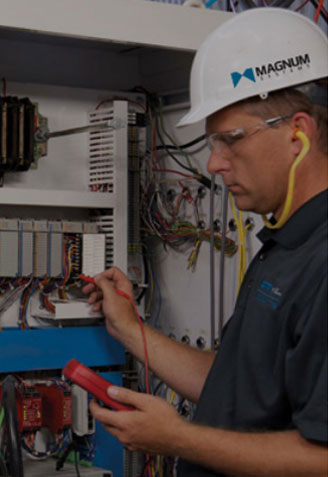 Man in hardhat at controls