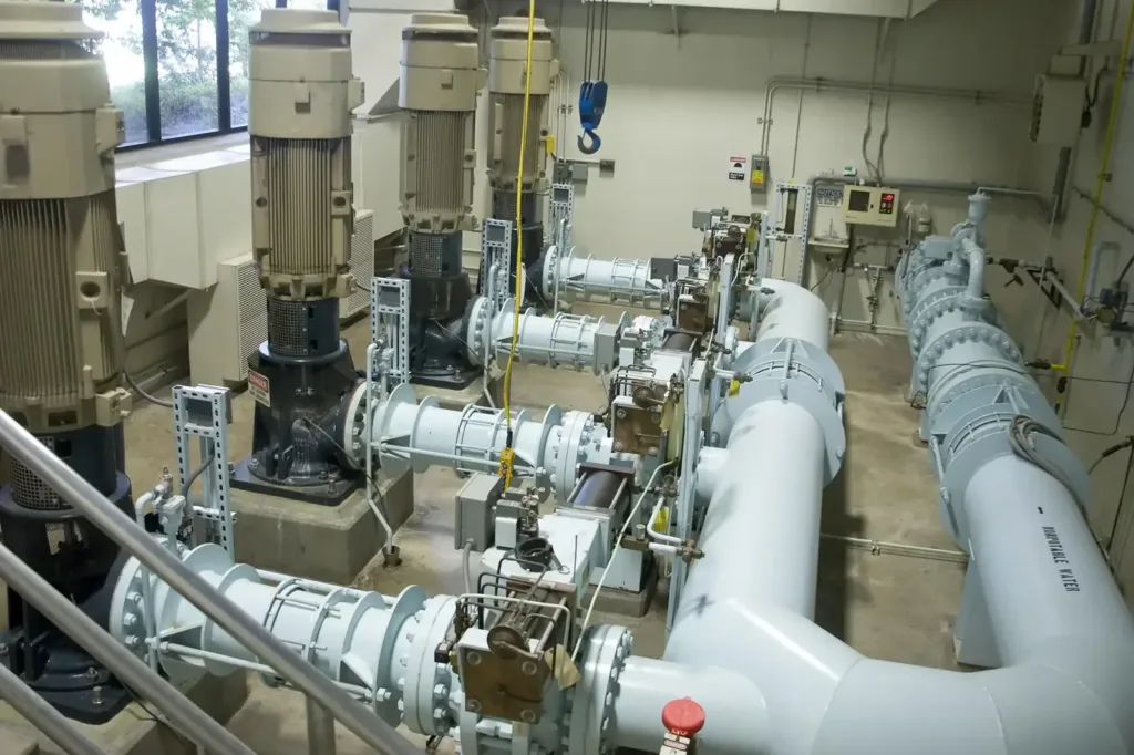 Four vertical pumps connected to light-blue piping labeled non-potable water inside a treatment pump station.